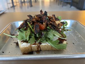 The Wellsbuilt Toast- Coconut bac'n, tomato, arugula, balsamic glaze, vegan mayonnaise, coarse salt & fresh-cracked pepper  at Easy Luck in Orlando