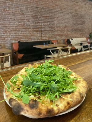 Vegan pesto pizza, with summer veggies and a handful of locally grown arugula at One Legged Magpie  in Red Lodge