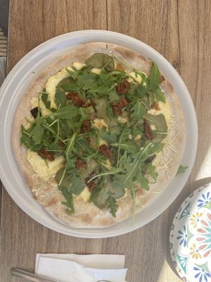 Pizza with sundried tomatoes, caramelised onions, mushroom, rocket, cheese   at Humus Vegan Tenerife in Tenerife