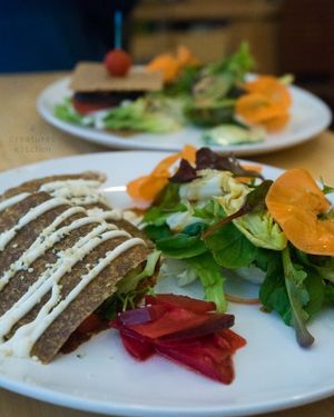 Raw quesadillas with salad, and the raw burger sandwich in the background.  at Raw8 Cafe in Osaka