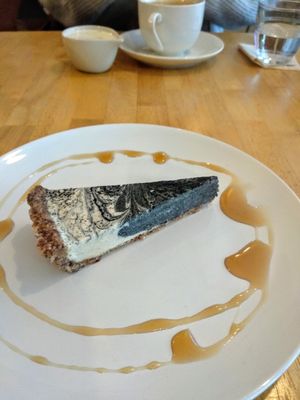 The delicious brown rice coffee and activated charcoal vegan cheesecake. Unique and delcious at Raw8 Cafe in Osaka