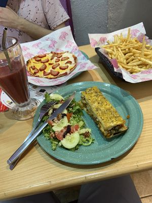 Fries, lasagna with side salad, fruit smoothie and Peach Pizza (which does not have peaches but does have sausage 😌)  at 31 Gatitos in Mexico City