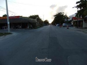 You can see Siempre Sano's sign out in the street behind the person walking at Puerto Verde in Puerto Morelos