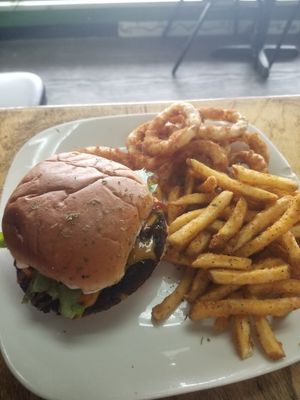 John's burger meal 2 sides and drink pictured with fries and onion rings at The Herbal Farmercy in Greenville