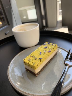 Raw cheese cake and coffee with oatmilk   at Loui in Munich