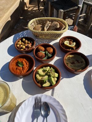 Olives, falafel, zaalouk (with lemon), hummus, avocado, and muhammara   at World Storytelling Cafe in Marrakech