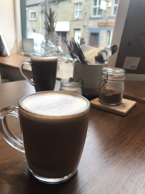 Oat Mocha front and hot chocolate back  at Thrive in Glossop
