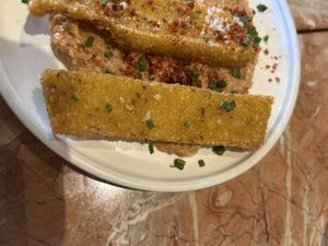 Ausgebratene Polentastreifen auf einer leckeren Sauce   at Chez Nina in Amsterdam