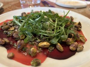 Rote Beete carpaccio mit Pistazien, Ruccola und Cashewcreme  at Chez Nina in Amsterdam