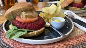 Vegan beetroot burger with caramelised onions and chips  at Carallo in San Jose