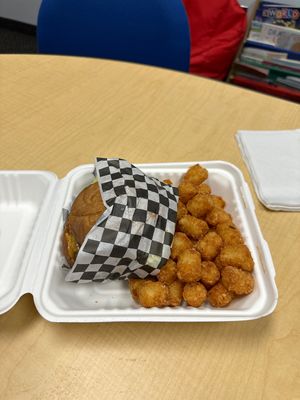 Green burger with vegan cheese and tater tots   at Twisted Burger Diner in Flint