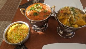 Saffron rice, tomato curry with vegan meat, cauliflower curry at King of Curries in Benalmadena