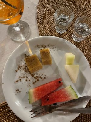 Raki shots, fruit & halva cake (seems vegan, they said no honey in it)  at Pelagos in Crete