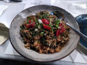 Cooked spinach with brown rice and cherry tomatoes. at Afrálato in Kalamata
