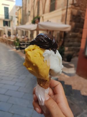 Mango, lemon and dark chocolate in a cone at Pappus Gelateria Artigianale in Noli