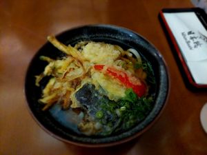 Vegan Tempura Udon: Wheat noodle soup with fried vegetables (Daikon radish, paprika and zucchini among others) and green onion at NihonBashi in Vienna