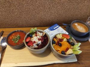 Selection of beans, porridge, fruit salad and a coffee at Pantry Brunch & Coffee in Budapest