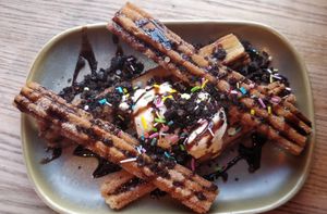 Churros 🤤 covered in chocolate sauce, oreo crumb & sprinkles served with Vanilla ice cream at Rabbit Food @ Meadows Tap in Edinburgh