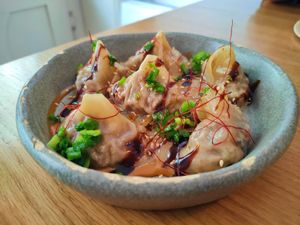 Wonton dumplings with shiitake mushrooms, soybean, sesame and chives. at Dwa Stoliki in Torun