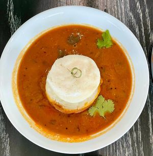 Steamed rice & lentil cake dunked in lentil stew (GF) at Pure Vegan Cafe in Durham