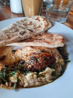 Topped hummus with pita at Station South in Manchester