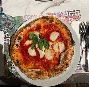Vegan options available. Margherita pizza. The dough was raw and not cooked. Comes with very little cheese and a fairly high price.  at Assaje in Udine