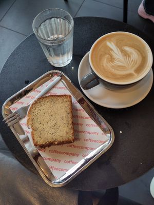 Vegan puppy seed cake + old Bourbon vanillia latte with Oat milk - medium at Coffee Company - Oude Doelenstraat in Amsterdam