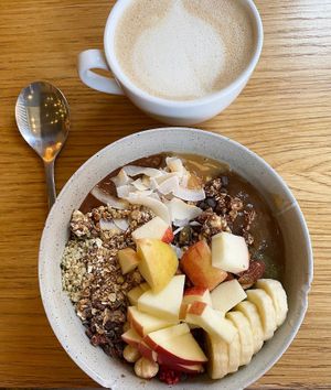 Vegan “ALL IN” toppings porridge and oat milk cappuccino  at Grød - Christianshavns in Copenhagen