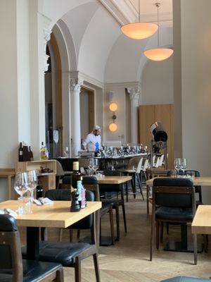 Grand, high ceilings, pizzas cooked in wood-burning oven  at Più Zug in Zug