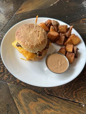 Bacon egg and cheese on a biscuit - comes with potatoes and spicy Mayo dipping sauce  at Scratch Breakfast in Vancouver