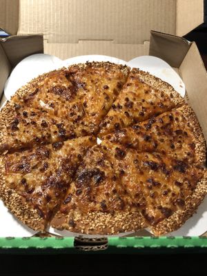 Perfectly done vegan cheese pizza with a cauliflower crust and sesame seeds   at Red Swan Pizza in Regina