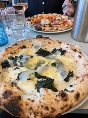 Pizza with red sauce - sweet & smoky (vegan); in front spinaci (vegetarian).   at Standard in Berlin