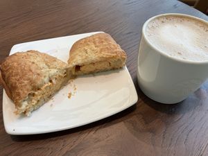 Vegan sausage croissants roll and hot latte with oat milk  at BLR - Starbucks  in Karnataka