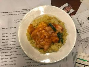 Rice with turmeric, mango and tofu skin (39k dongs), what you see is a whole plateful of rice and just a tiny ";dressing"; spread on top at Minh Hien in Hoi An