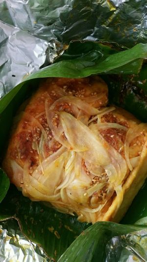 stuffed Stuffed tofu w onion, mashrooms, garlic and curry rolled in banana leaf and steamed (have a bit of a sweet flavor)    at Minh Hien in Hoi An