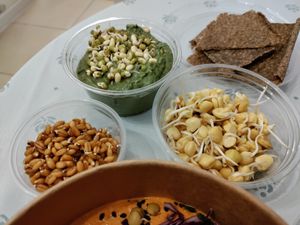Avocado dip, sprouted wheat and sweet pea, and crackers at UMMY - უმმი in Tbilisi