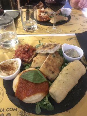 Vegan ”Appetizer Ghisa” (mini pizza, veg empanada, bread, bruschetta, hummus & babaganoush)  at Ghisa in Catania