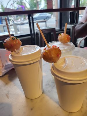 Hot drinks topped with doughnut holes at Dough Joy in Seattle
