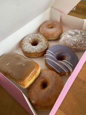 Half dozen box with a Maple bar, plain/classic glazed x2, French toast, lavender vanilla, and lemon filled  at Dough Joy in Seattle