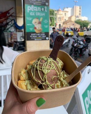 Nutella scoop with pistachio sauce on waffles with edible spoon)  at Plan(e)t Ice Cream in Athens