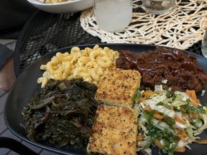 Smoked BBQ plate with bbq jackfruit, cornbread, greens, and mac and cheese  at Vegan A.F. in Brattleboro
