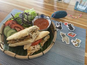 Vegan crispy tofu sandwich and some goodies you can buy to help feed the cats  at The Happy Cat - Veggie Cafe-Restaurant in Luang Prabang