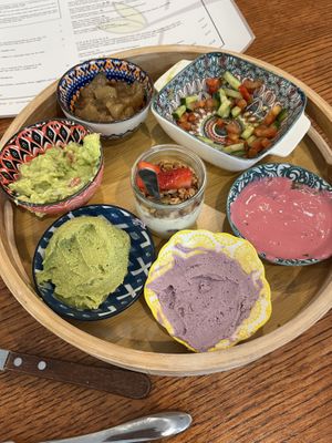 Part of plant based breakfast for 2 - hummus, beet tahini, Lebanese salad, vegan yogurt and granola, etc   at Café Alma in Cincinnati