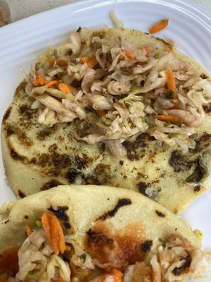 “Cheese” and loroco pupusa, “cheese” and veggies pupusa. Curtido (pickled cabbage and carrot) on top  at La Sabrosa Sweets in Los Angeles