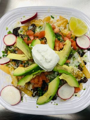 Papa Nachos:  fries, beans, vegan cheese, veggies ( mushroom, zucchini, carrots, spinach) vegan sour cream, pico de gallo  at La Sabrosa Sweets in Los Angeles