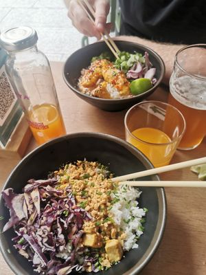 Tofu satay (vegan) and sweet sour chicken in the background at My Little Warung in Lyon