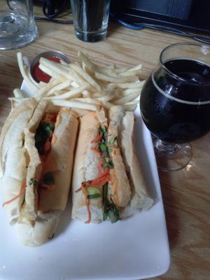banh mi sandwich with fries and almond milk stout at Golden Road Brewing - West Glendale in Los Angeles