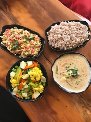 All vegan. Steamed veggies, veggies with hummus and peanut stew with brown rice at Millets of Mewar in Udaipur