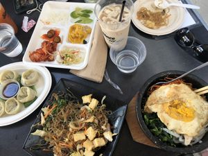 Thai iced tea, banchan, dumplings, japche, bibimbap   at Sura Korean BBQ & Tofu House in Long Beach