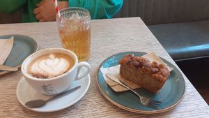 Oat milk cappuccino, apple juice and banana bread at Gaard 2 Coffee Hide in Sheffield